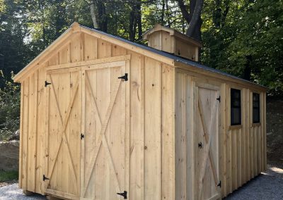 Beautiful Amish Built Sugar shack with a red roof in the woods in fall