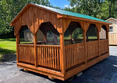 Amish Built Gazebo with railings, screens, and a green roof