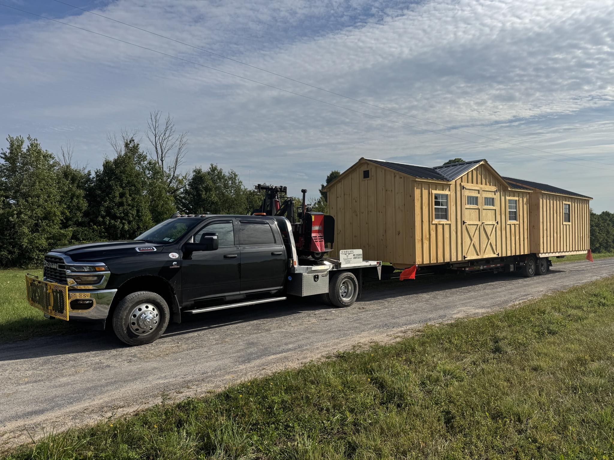 Transport company delivering a shed