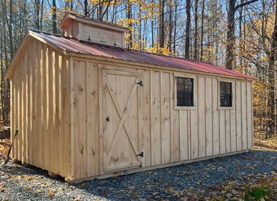 Red Roofed Amish Sugar Shack in the Fall Woods