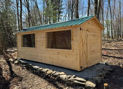 Large Sauna with Green Roof and Two Windows in the Woods
